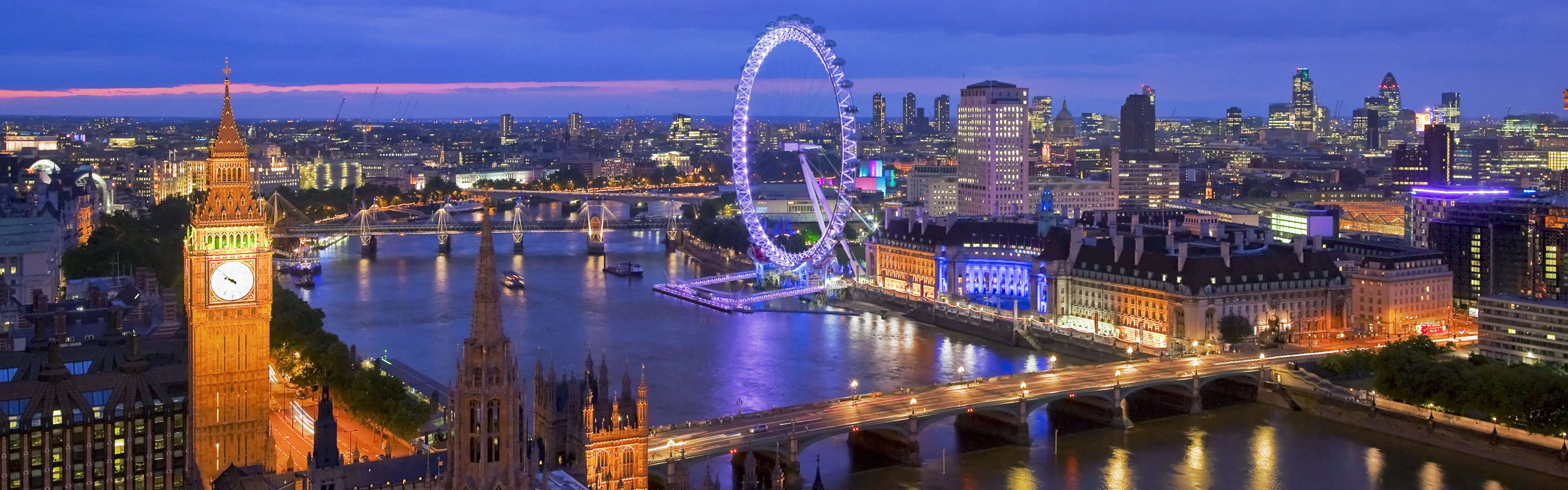 Panoramic view from Victoria Tower on Houses of Parliament and London skyline at night, London, U.K.